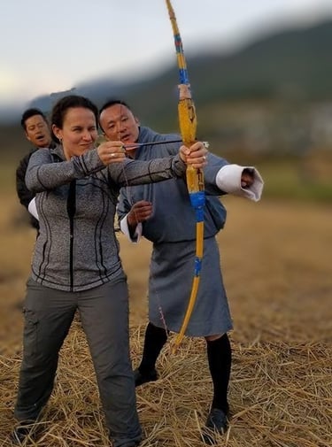 drukyul_delights_ceo_with_guest_experiencing_archery_session_in_punakha_bhutan