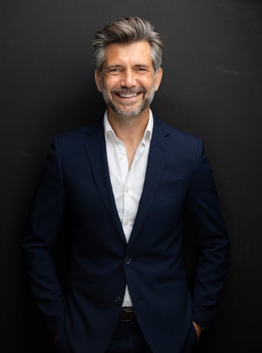 Akin Karaca, a Fractional CFO in a suit and a white shirt