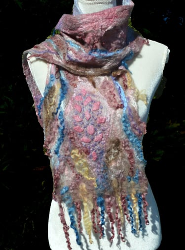 Handmade nuno felted cobweb wool scarf with pink and blue details on a white mannequin torso.