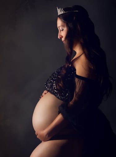 a pregnant woman wearing a tiaper and a tiaper crown