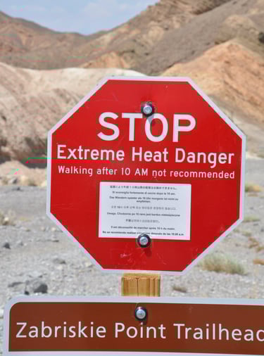 a stop sign warning of extreme heat at zabreski point, Death Valley