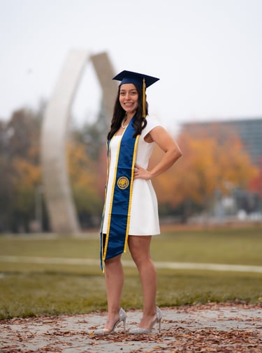 woman posing for her graduation portraits being taken by a photographer