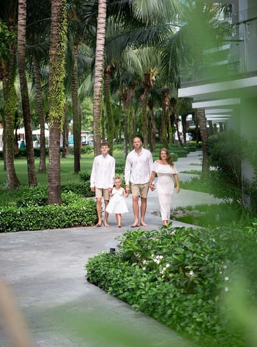 Family walking through Premier Residences Phu Quoc gardens