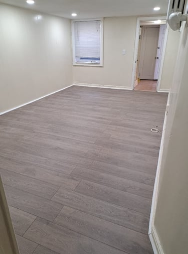 Renovated living room with new floors and recessed lights.