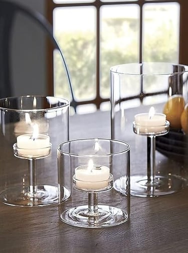 Tall hurricane tea light candle holders with white candles for cosy home décor.