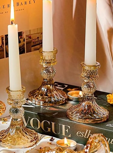 Crystal glass candlesticks set displayed on a gold tray, elegant table décor.