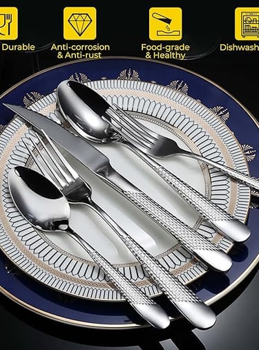 Silver hammered cutlery set styled on textured white dinner plates.