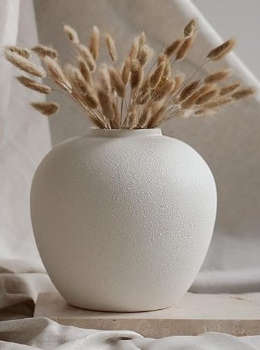 White textured ceramic vase with dried grass stems, minimal modern home décor.