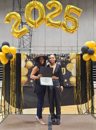 two women in black tops smiling and holding a certificate 