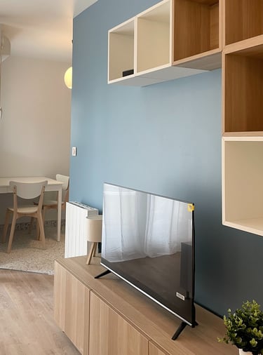 a flat screen tv sitting on a wooden entertainment center