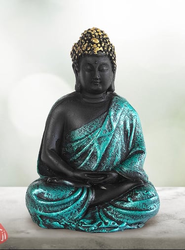 a statue of a buddha statue sitting on a table