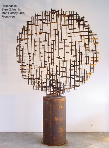 a rusted steel cross-hatched  circle sculpture on a rusted cylinder base 