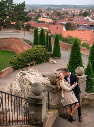  Couple kissing on Mikulov Castle stairs with panoramic red rooftop town view behind them