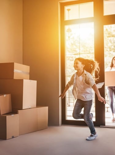 a woman is moving into a new clean home with boxes and her family
