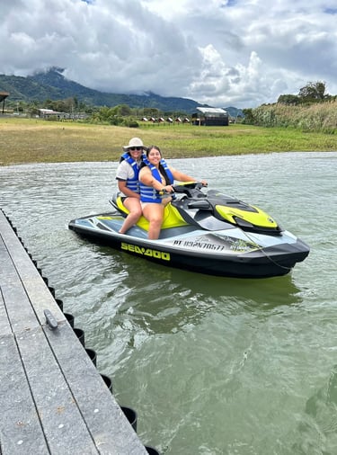 a woman and a man riding a jet skis