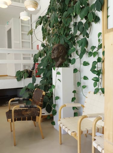Bright interior with Alvar Aalto style chairs, greenery and natural light for a cozy modern home