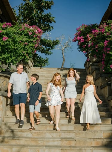 Family walking down the stone staircase during a family photography session at AYANA Resort Bali