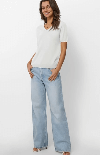 a woman in a white shirt and jeans jeans