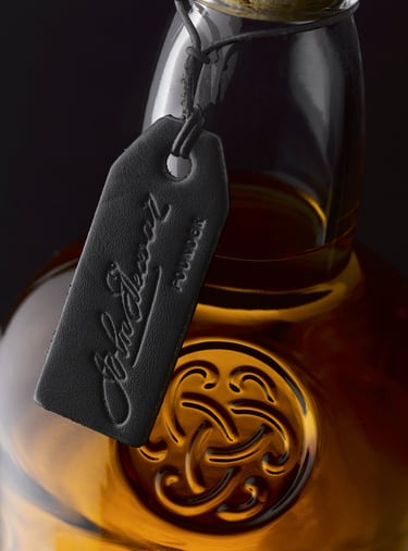 Close up of black leather tag on neck of Dewars whiskey bottle