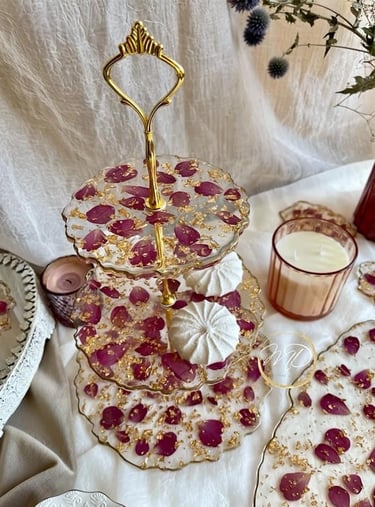 tiered dessert stand with a cake, made from epoxy resin, rose petals decor