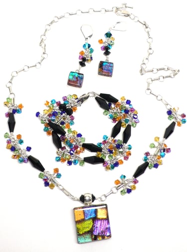Dichroic glass with Austrian crystal and sterling silver. Necklace, earrings and bracelet.