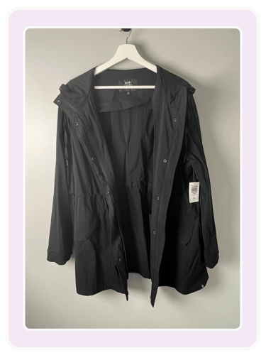 Happy Camper by Torrid jacket for women hanging on a white hanger against a grey wall.