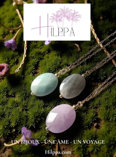 Handmade Hilppa gemstone necklaces with oval pendants in aquamarine, labradorite, and lavender quartz on green moss.