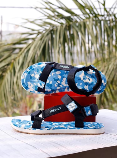 a pair of sandals with a blue and white flowered sandals