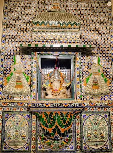 Colorful glass and tile patterns inside Ganesh Deodi, Udaipur City Palace museum entry gate.