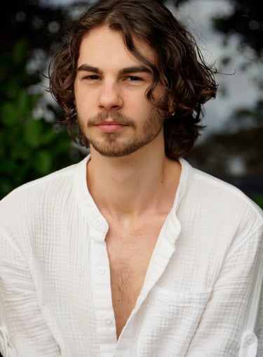 a man with a beard and a white shirt