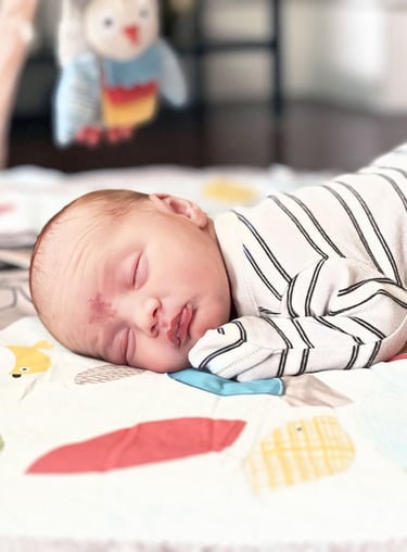 a baby sleeping on a blanket