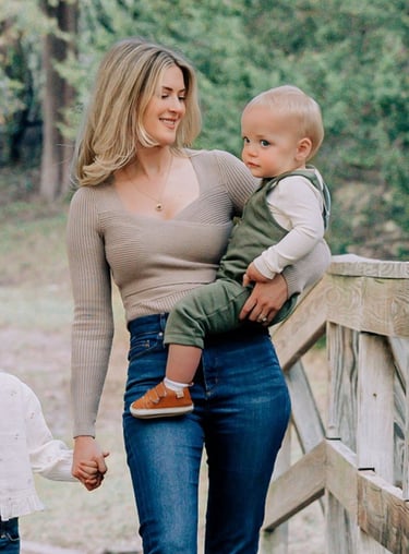 an adoption consultant woman holding a baby in her arms