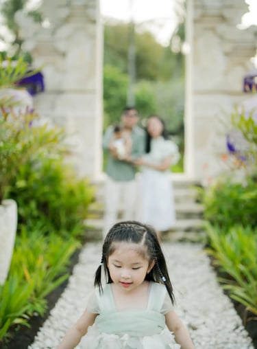 Family standing at a traditional Balinese gate during a family photography session in Nusa Dua Bali.