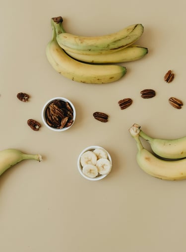 bananas and pecans on a table with nuts