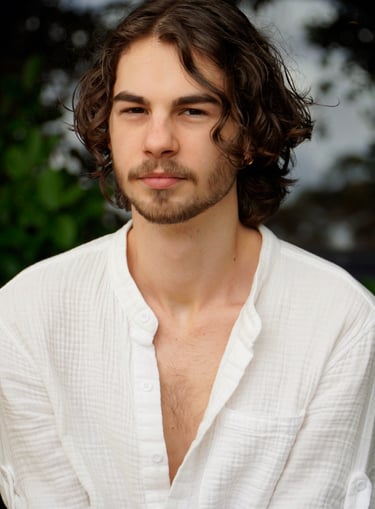 a man with a beard and a white shirt