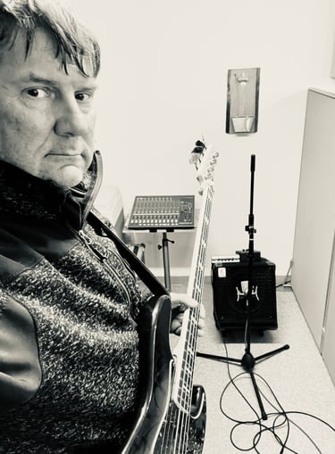 Der Bassist mit seiner Bassgitarre im Aufnahmestudio