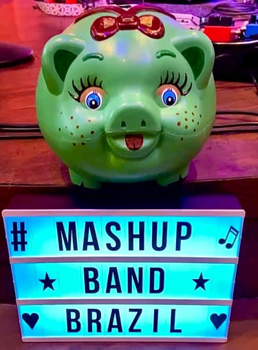 A green pig bank with a light sign with a written saying Mashup Band Brazil.