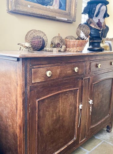Image of a sideboard that is brown wood and could be painted