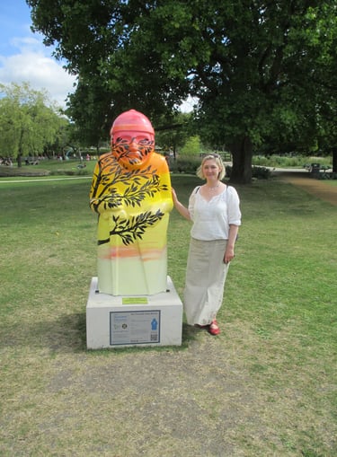 A sculpture for the Baron's trail painted with a sunset and silhouette tree