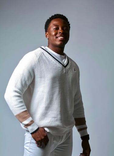 a man in a white sweater and white pants