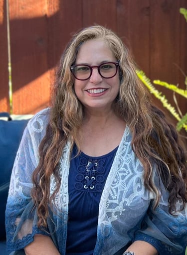 a woman in glasses and a blue shirt