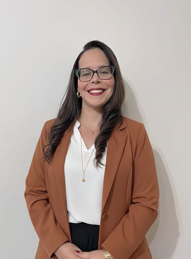a woman in a brown blazer and glasses