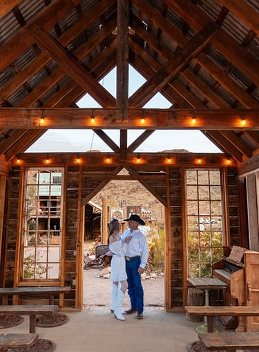 a man and woman standing in a Wedding Chapel at Nelson Ghost Town