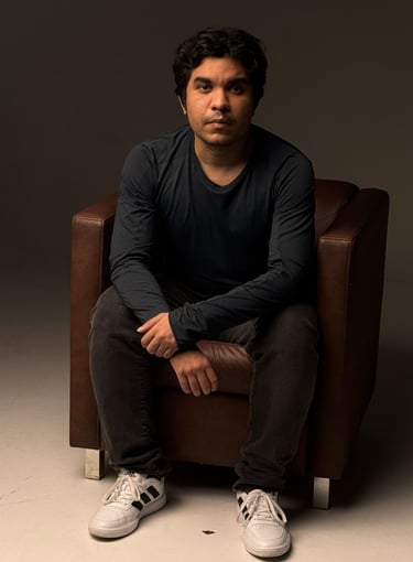 a man sitting in a chair with his feet on the ground. CEO Of RecomendeMe