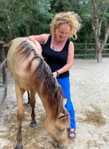 Sunni Dawson with a horse in a rural setting—reflecting intuitive connection
