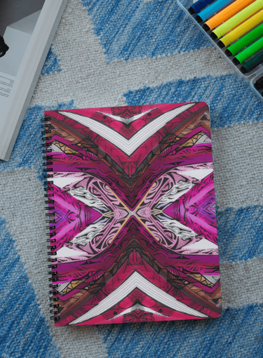 a notebook with a pink and white design