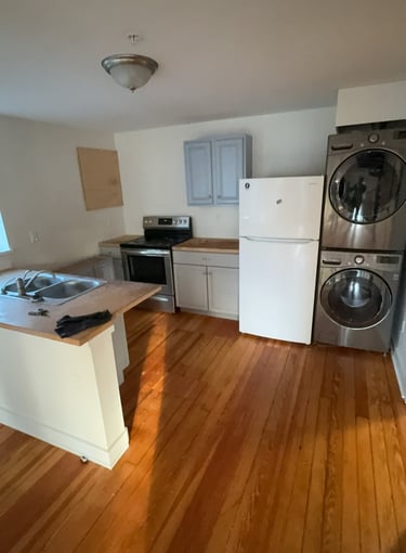 Washing machine and dryer being removed from basement during cleanout