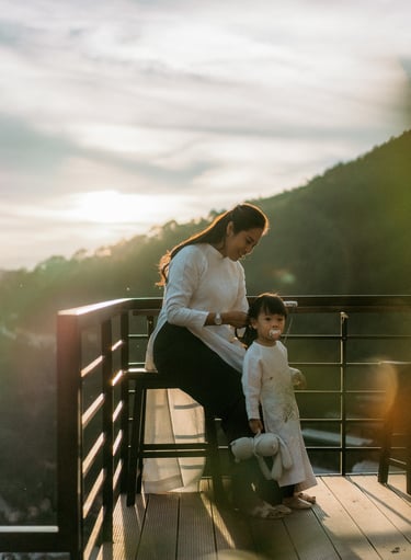 a woman sitting on a bench with her two children