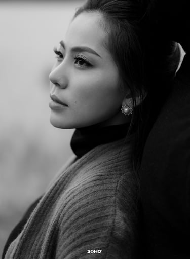 a woman with a ponytail hairstyled in a black and white photo