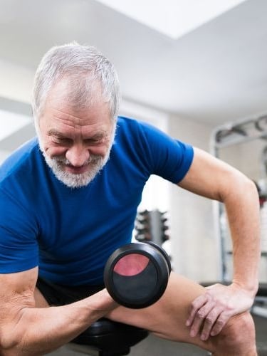 George Eleter holding a dumbble